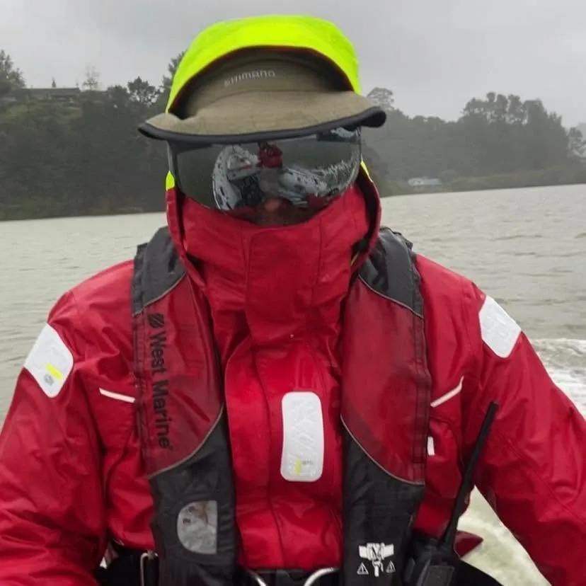 Tim in red wet-weather gear, goggles and a face cover, ready for rough weather