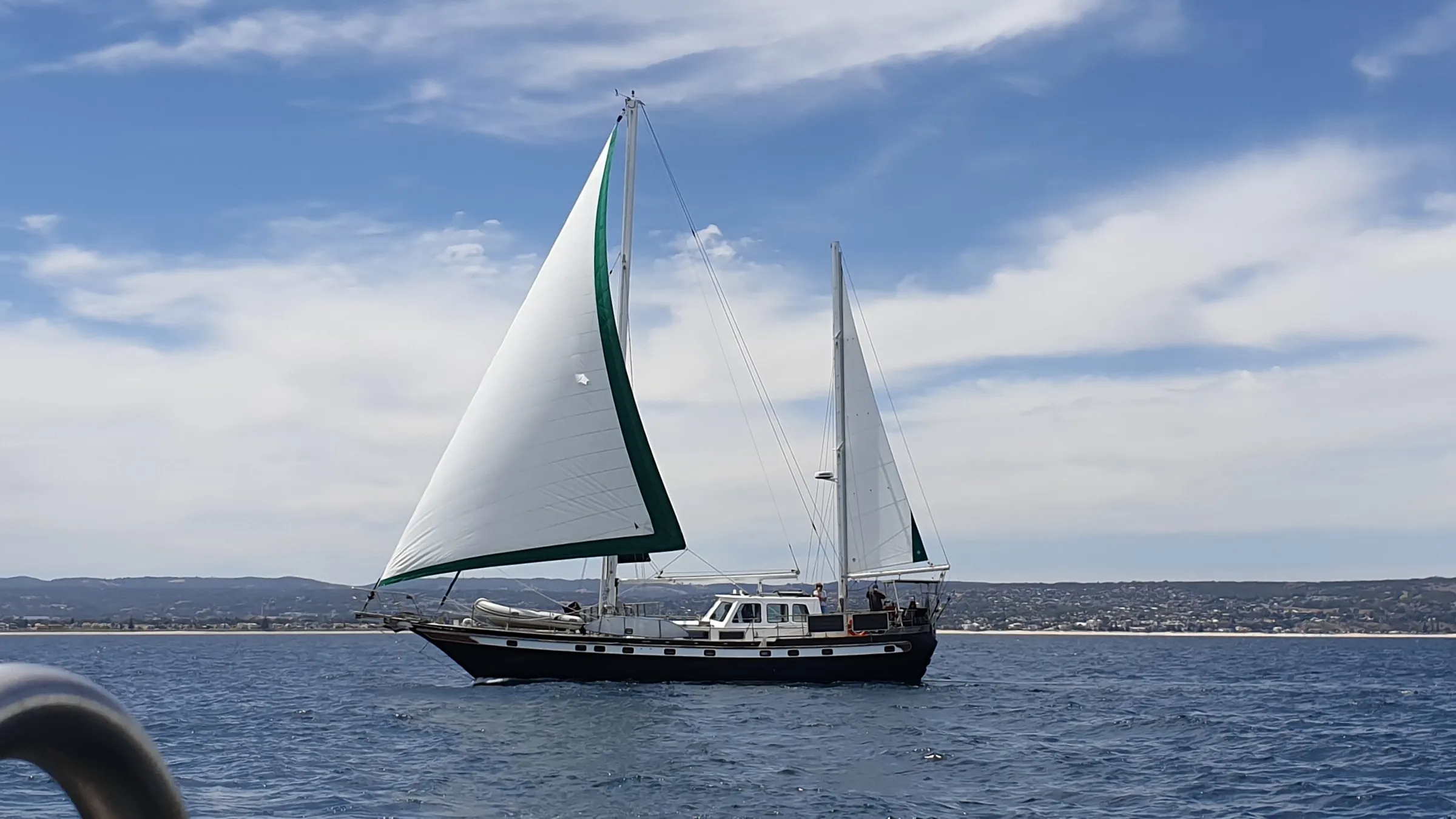 Sea Dragon under full sail off the South Australian coast in 2023, before her repaint